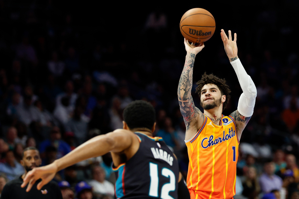 Charlotte Hornets guard LaMelo Ball (1) prepares to take a jump shot against Detroit Pistons forward Tobias Harris (12) during the first half of an NBA basketball game in Charlotte, N.C., Friday, April 10, 2026. (AP Photo/Nell Redmond)