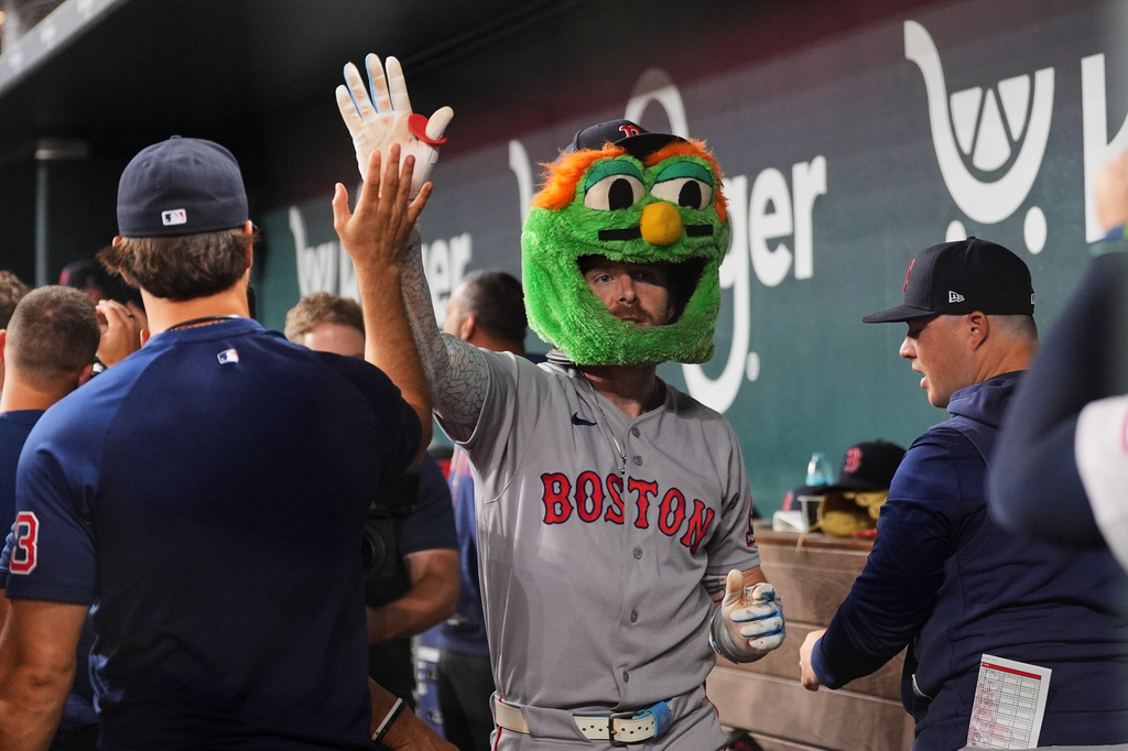 Boston Red Sox's Trevor Story, center, celebrates with the team after hitting a three-run home run in the eighth inning of a baseball game against the Texas Rangers Thursday, Sept. 17, 2026, in Arlington, Texas (AP Photo/Tony Gutierrez)