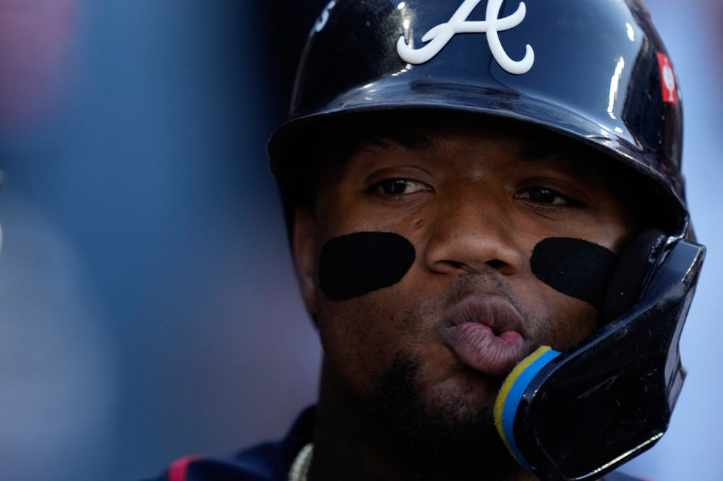 Atlanta Braves' Ronald Acu&ntilde;a Jr. celebrates with teammates after scoring off an RBI single by Mauricio Dub&oacute;n during the first inning of Game 2 of a National League Division Series baseball game against the Los Angeles Dodgers Sunday, Oct. 4, 2026, in Los Angeles. (AP Photo/Mark J. Terrill)