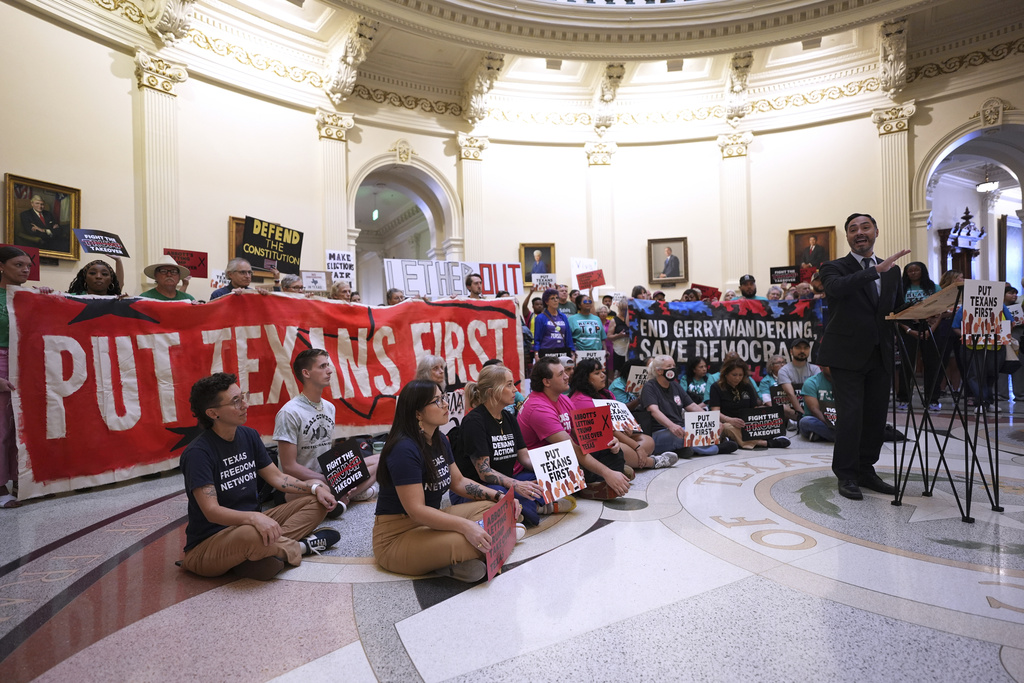 U.S. Congressman Joaquin Castro, right, speaks to protesters gather in the rotunda outside the House Chamber at the Texas Capitol as lawmakers debate a redrawn U.S. congressional map in Texas during a special session, Wednesday, Aug. 20, 2025, in Austin, Texas. (AP Photo/Eric Gay)
