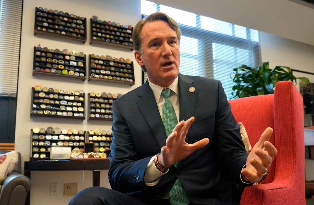 Virginia Gov. Glenn Youngkin gestures during an interview in his office at the Capitol Wednesday Dec. 10, 2025, in Richmond, Va. (AP Photo/Steve Helber)