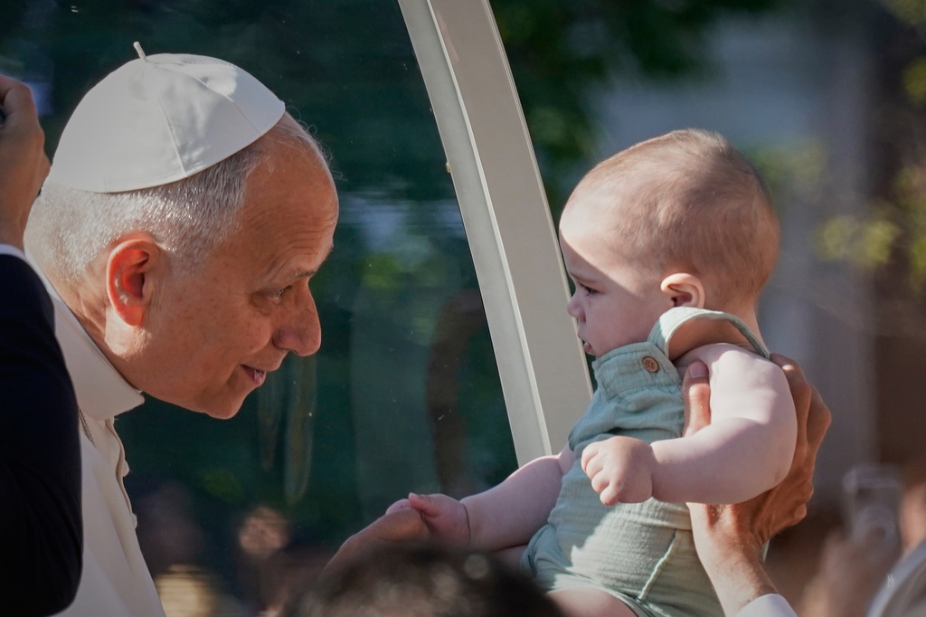 Pope Leo XIV greets a child upon arriving in the popemobile at Plaza de Cibeles for a Holy Mass and Corpus Christi procession in Madrid, Spain, Sunday, June 7, 2026, on the second day of his seven-day apostolic visit to mainland Spain and the Canary Islands. (AP Photo/Andrea Comas)