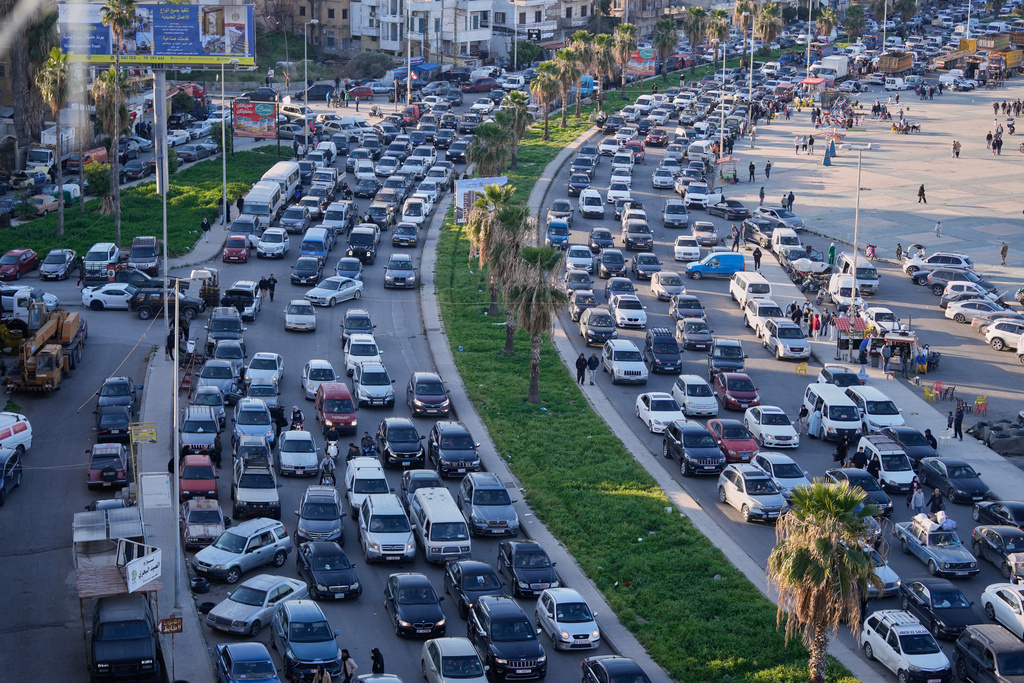 Displaced people fleeing Israeli strikes in southern Lebanon sit in traffic at a highway links to Beirut, in the southern port city of Sidon, Monday, March 2, 2026. (AP Photo/Mohammed Zaatari)