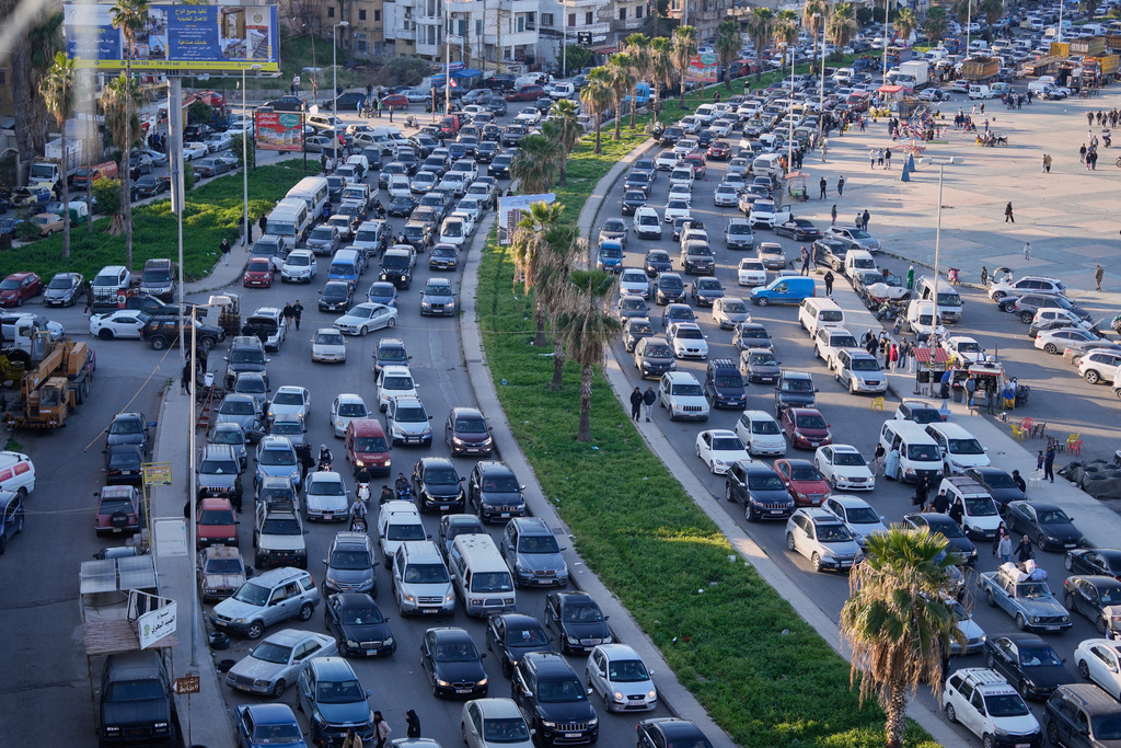 Displaced people fleeing Israeli strikes in southern Lebanon sit in traffic at a highway that links to Beirut, in the southern port city of Sidon, Monday, March 2, 2026. (AP Photo/Mohammed Zaatari)