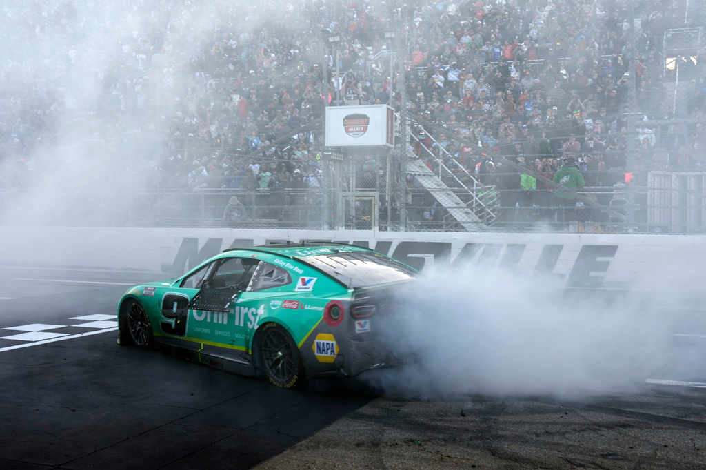 Chase Elliott (9) performs a burnout after winning a NASCAR Cup Series auto race in Martinsville, Va., Sunday, March 29, 2026. (AP Photo/Chuck Burton)