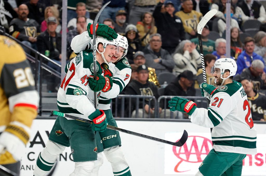 Minnesota Wild center Michael McCarron (47) celebrates with defenseman Brock Faber (7) and center Robert Fabbri (21) after scoring against the Vegas Golden Knights during the second period of an NHL hockey game, Friday, March 6, 2026, in Las Vegas. (Steve Marcus/Las Vegas Sun via AP)