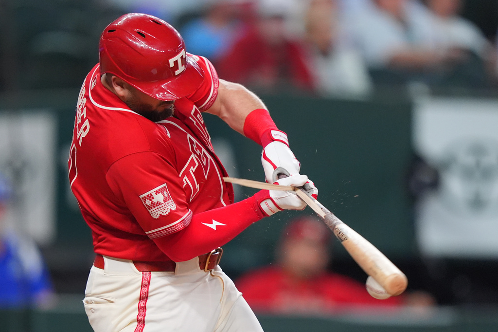 Texas Rangers' Jake Burger breaks his bat while grounding out during the third inning of a baseball game against the Kansas City Royals, Friday, May 29, 2026, in Arlington, Texas. (AP Photo/LM Otero)
