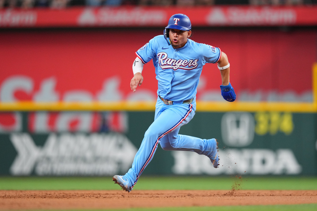Texas Rangers' Alejandro Osuna runs the bases before scoring on a double by Kyle Higashioka during the first inning of a baseball game against the Kansas City Royals, Sunday, May 31, 2026, in Arlington. (AP Photo/Julio Cortez)