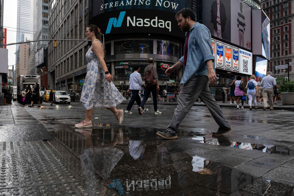 People walk past the Nasdaq MarketSite, Thursday, Aug. 6, 2026, in New York. (AP Photo/Yuki Iwamura)