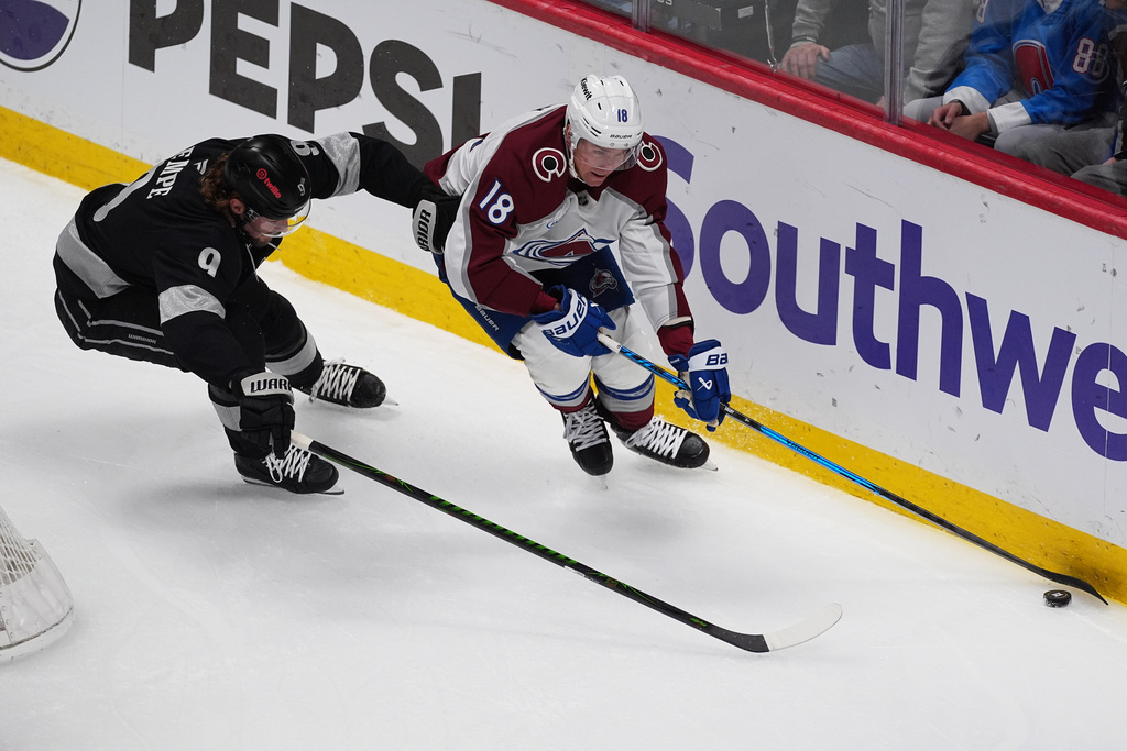 Colorado Avalanche center Jack Drury, right, collects the puck as Los Angeles Kings right wing Adrian Kempe, left, defends in the first period of an NHL hockey game Monday, Dec. 29, 2025, in Denver. (AP Photo/David Zalubowski)
