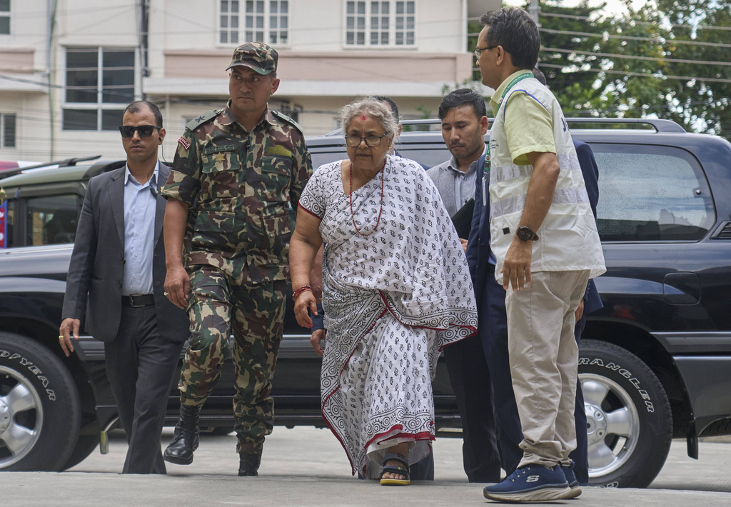 Nepal's interim prime minister Sushila Karki, center, arrives at Civil hospital to meet people injured during anti-corruption protests sparked by a short-lived social media ban in Kathmandu, Nepal, Saturday, Sept. 13, 2025. (AP Photo/Niranjan Shrestha)
