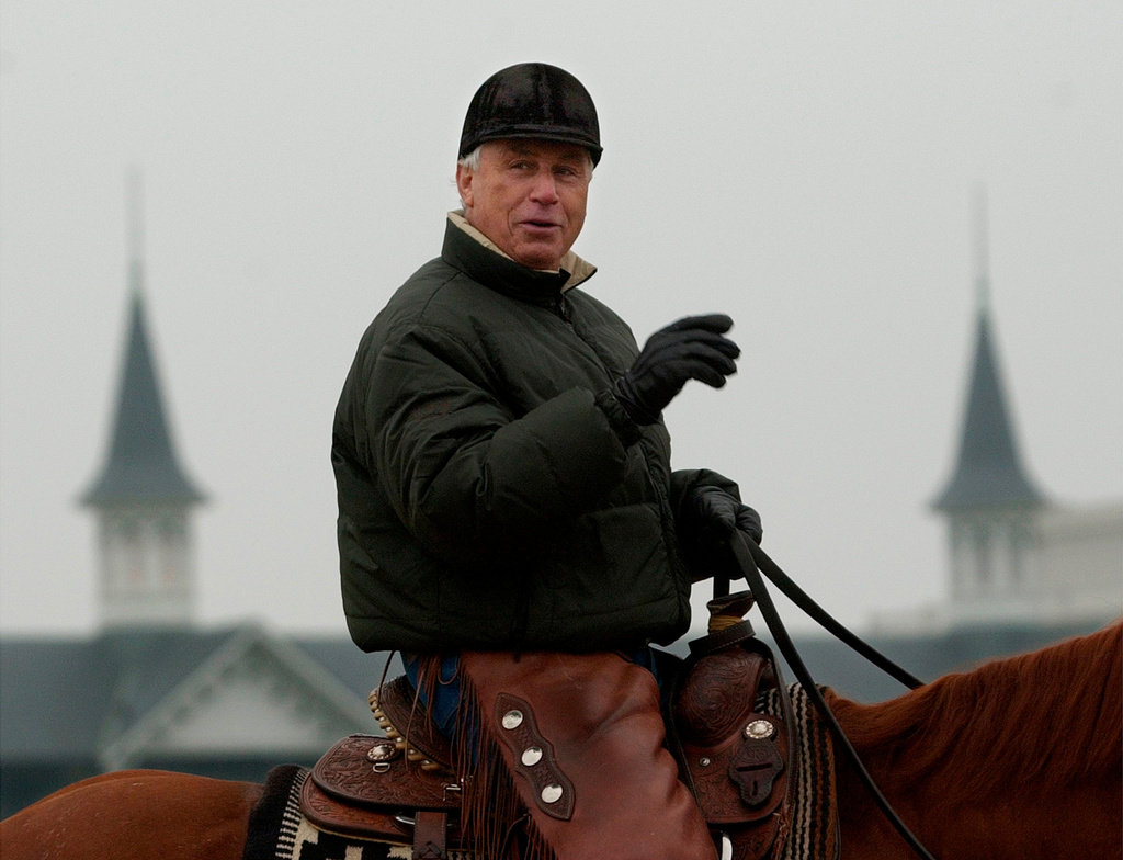 FILE - Hall of Fame trainer D. Wayne Lukas is framed by the twin spires of Churchill Downs as he talks with friends Saturday, April 30, 2005, in Louisville, Ky. (AP Photo/Ed Reinke, File)