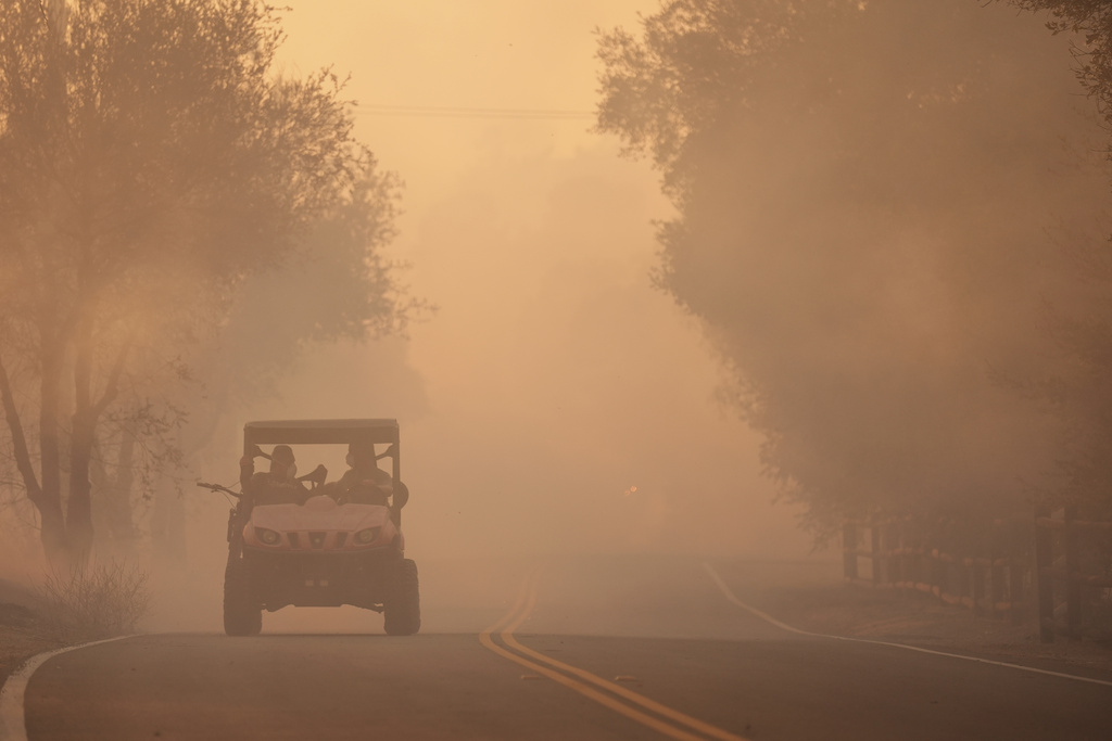 Residents evacuate as the Canyon Fire burns on Thursday, Aug. 7, 2025, in Hasley Canyon, Calif. (AP Photo/Marcio Jose Sanchez)