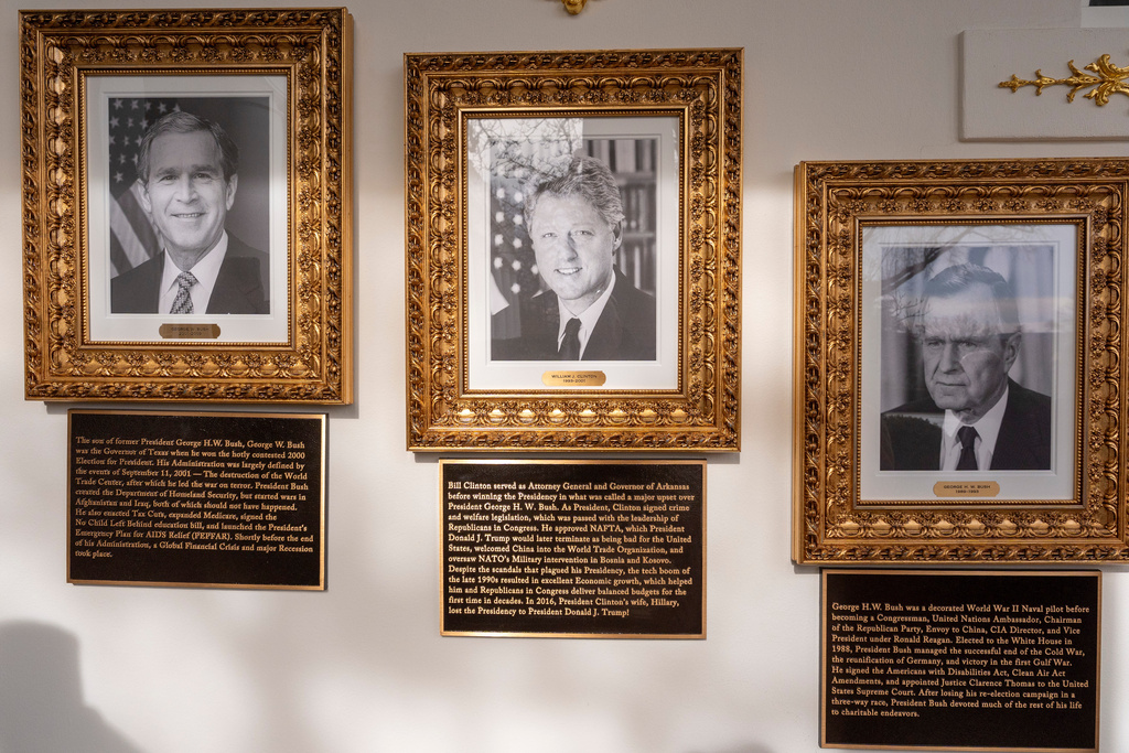 New plaques of explanatory text have been placed underneath presidential portraits on the Colonnade at the White House, Wednesday, Dec. 17, 2025, in Washington. (AP Photo/Alex Brandon)