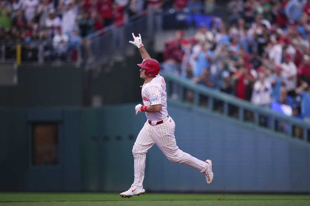 Philadelphia Phillies' J.T. Realmuto reacts after hitting a home run against Seattle Mariners pitcher Logan Gilbert during the second inning of a baseball game Monday, Aug. 18, 2025, in Philadelphia. (AP Photo/Matt Slocum)