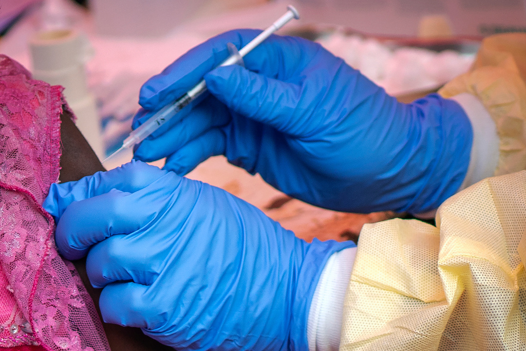 FILE - In this Saturday, July 13, 2019 file photo, a person is vaccinated against Ebola in Beni, Congo. (AP Photo/Jerome Delay, File)