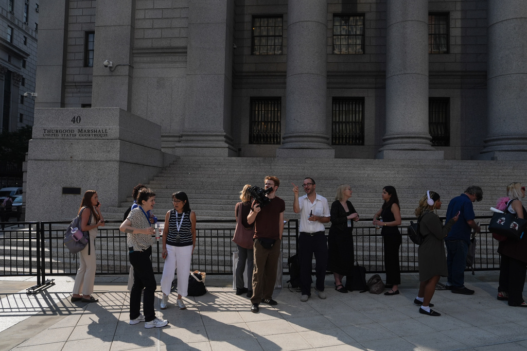 Members of the media wait in line outside of Manhattan Federal Court on the day of a hearing for Luigi Mangione on Friday, Aug. 14, 2026, in New York. (AP Photo/Ryan Murphy)