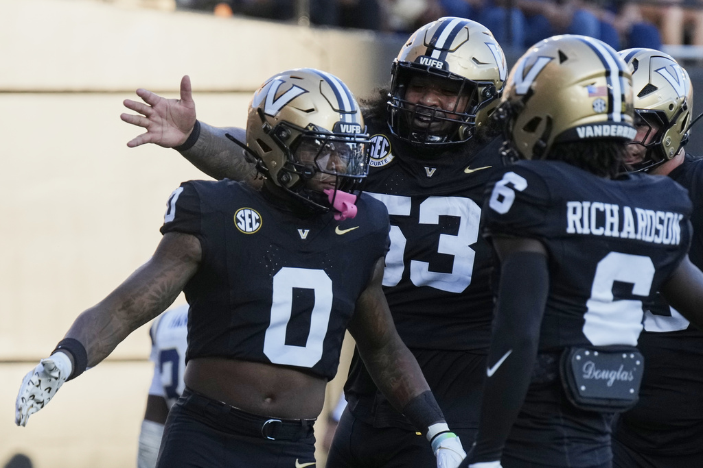 Vanderbilt wide receiver Junior Sherrill (0) celebrates his touchdown with offensive lineman Jordan White, center, and wide receiver Tre Richardson (6) during the first half of an NCAA college football game against Charleston Southern, Saturday, Aug. 30, 2025, in Nashville, Tenn. (AP Photo/George Walker IV)