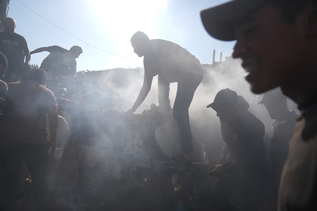 People operate on a destroyed vehicle following an Israeli airstrike in Gaza city, Saturday, Sept. 19, 2026. (AP Photo/Jehad Alshrafi)