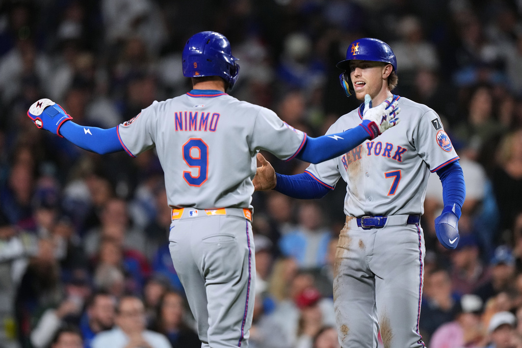 New York Mets' Brett Baty, right, celebrates with New Brandon Nimmo after scoring on a two-run double by Tyrone Taylor during the sixth inning of a baseball game against the Chicago Cubs in Chicago, Thursday, Sept. 25, 2025. (AP Photo/Nam Y. Huh)