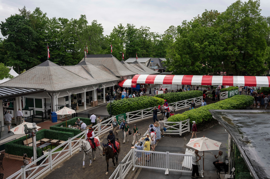 Jockeys walk thoroughbreds to the track for the second race of the day before the 158th running of the Belmont Stakes horse race at Saratoga Race Course, Saturday, June 6, 2026, in Saratoga Springs, N.Y. (AP Photo/Yuki Iwamura)