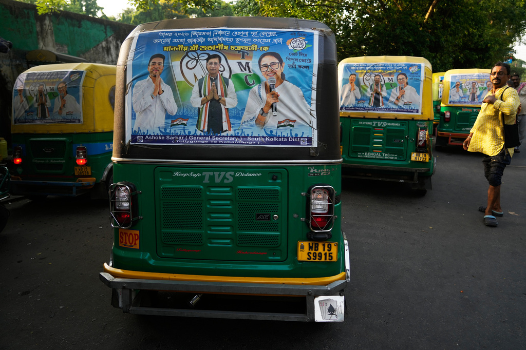 Posters with Trinamool Congress party chief Mamata Banerjee are fixed on back of auto-rickshaws ahead of the West Bengal state Legislative Assembly elections, in Kolkata, India, Wednesday, April 22, 2026. (AP Photo/Bikas Das)