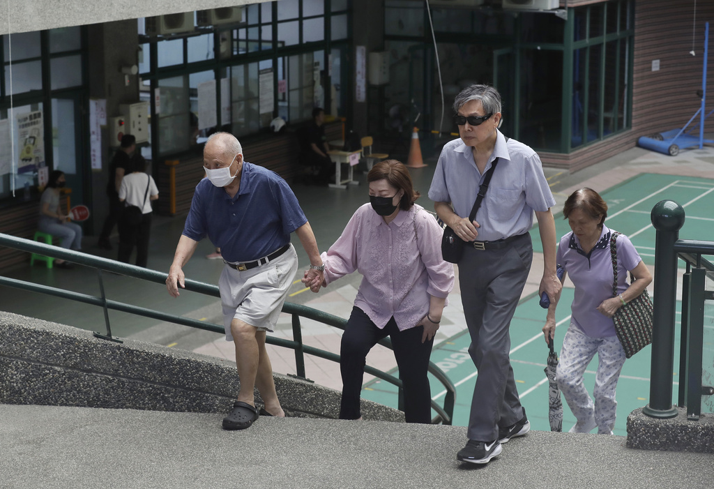 People arrive at a polling station in Taipei, Taiwan, Saturday, Aug. 23, 2025, during the vote which includes a referendum on restarting the Maanshan nuclear power plant. (AP Photo/Chiang Ying-ying)
