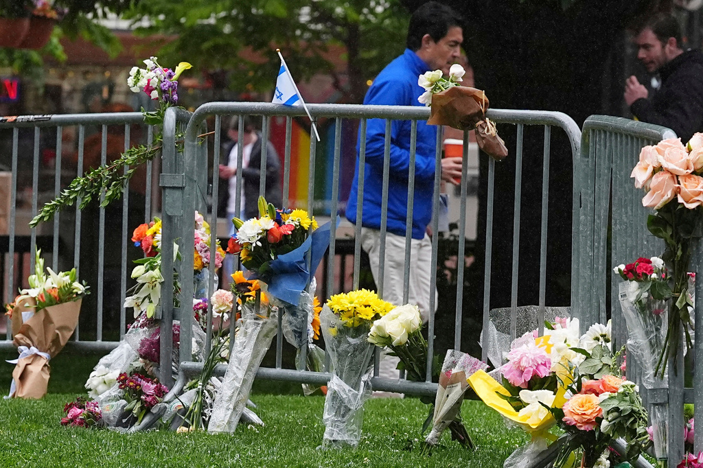FILE - Bouquets of flowers stand along a makeshift memorial for victims of an attack outside of the Boulder County courthouse on June 3, 2025, in Boulder, Colo. (AP Photo/David Zalubowski, file)