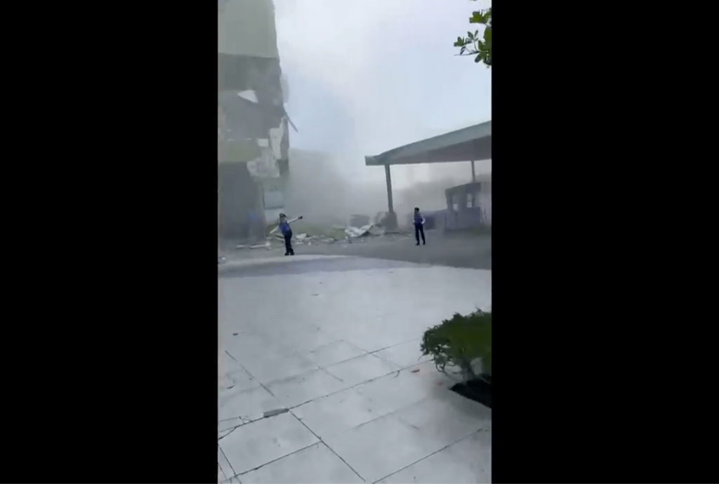 This image from a video shows dust and debris outside a building after a powerful earthquake in General Santos city on the island of Mindanao, Philippines Monday, June 8, 2026. (Ernesto Torres Jr via AP)