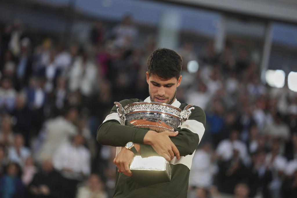 FILE - Spain's Carlos Alcaraz celebrates with the trophy after winning the final match of the French Tennis Open against Italy's Jannik Sinner at the Roland-Garros stadium in Paris, June 8, 2025. (AP Photo/Thibault Camus, File)