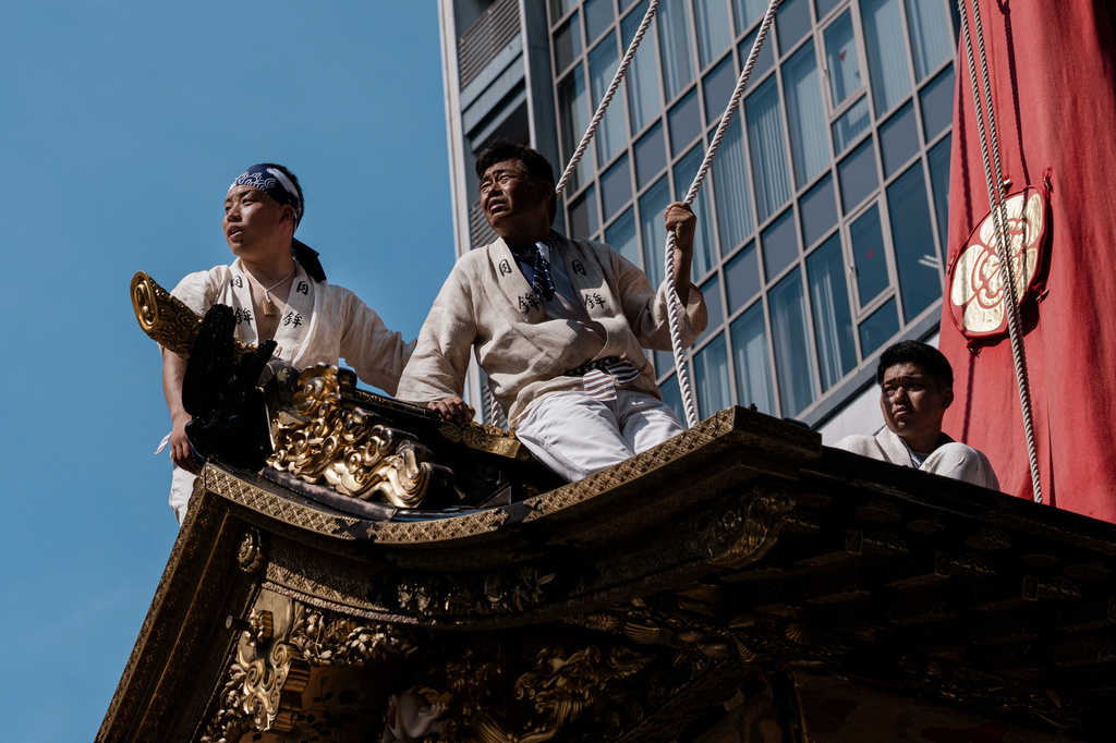 Festivalgoers are seen atop a festival float during one of the main parades of Shinto's Gion Matsuri festival in Kyoto, western Japan, Friday, July 17, 2026. (AP Photo/Fred Mery)