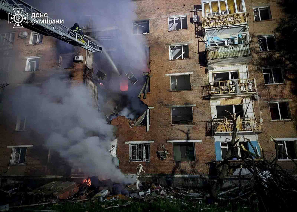 In this photo provided by the Ukrainian Emergency Services on Wednesday, May 20, 2026, rescue workers put out a fire of a residential building damaged after a Russian strike on Konotop, Ukraine. (Ukrainian Emergency Service via AP)