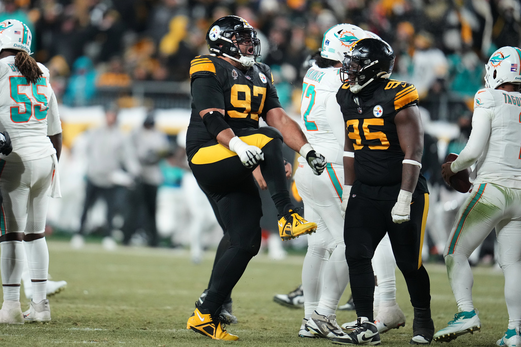 Pittsburgh Steelers defensive tackle Cameron Heyward (97) celebrates after sacking Miami Dolphins' Tua Tagovailoa as Keeanu Benton (95) looks on in the second half of an NFL football game in Pittsburgh, Monday, Dec. 15, 2025. (AP Photo/Gene J. Puskar)