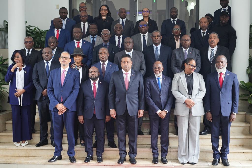 Haiti's Prime Minister Alix Didier Fils-Aimé, front row, left, and his cabinet pose for a group photo with members of the presidential council at a ceremony marking the end of their almost two-year rule, in Port-au-Prince, Saturday, Feb. 7, 2026. (AP Photo/Odelyn Joseph)