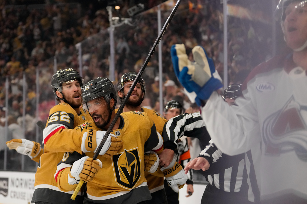 Vegas Golden Knights right wing Keegan Kolesar, second from left, is held back after Colorado Avalanche defenseman Josh Manson, right, shoved him into the boards after Kolesar scored during the second period in Game 3 of the Western Conference finals NHL hockey Stanley Cup playoff series Sunday, May 24, 2026, in Las Vegas. (AP Photo/Mark J. Terrill)