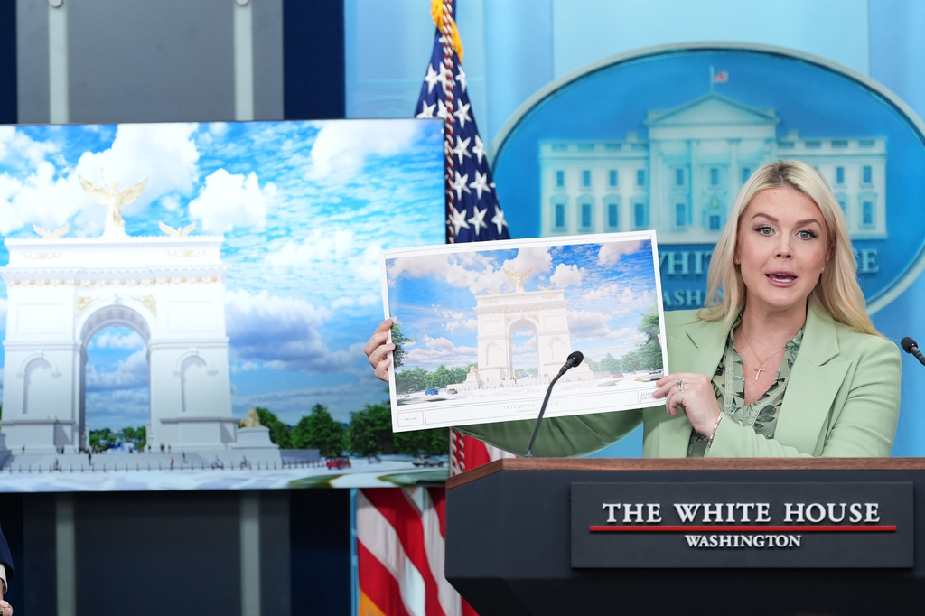 White House press secretary Karoline Leavitt holds up an artist rendering of the new triumphal arch as she speaks with reporters in the James Brady Press Briefing Room at the White House, Wednesday, April 15, 2026, in Washington. (AP Photo/Alex Brandon)