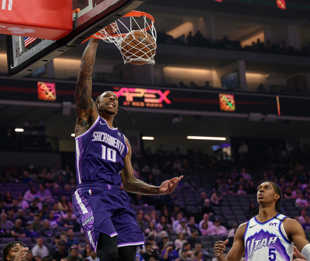 Sacramento Kings guard DeMar DeRozan (10) dunks the ball over Utah Jazz forward Cody Williams (5) during the second half of an NBA basketball game in Sacramento, Calif., Sunday, March 15, 2026. (AP Photo/Randall Benton)
