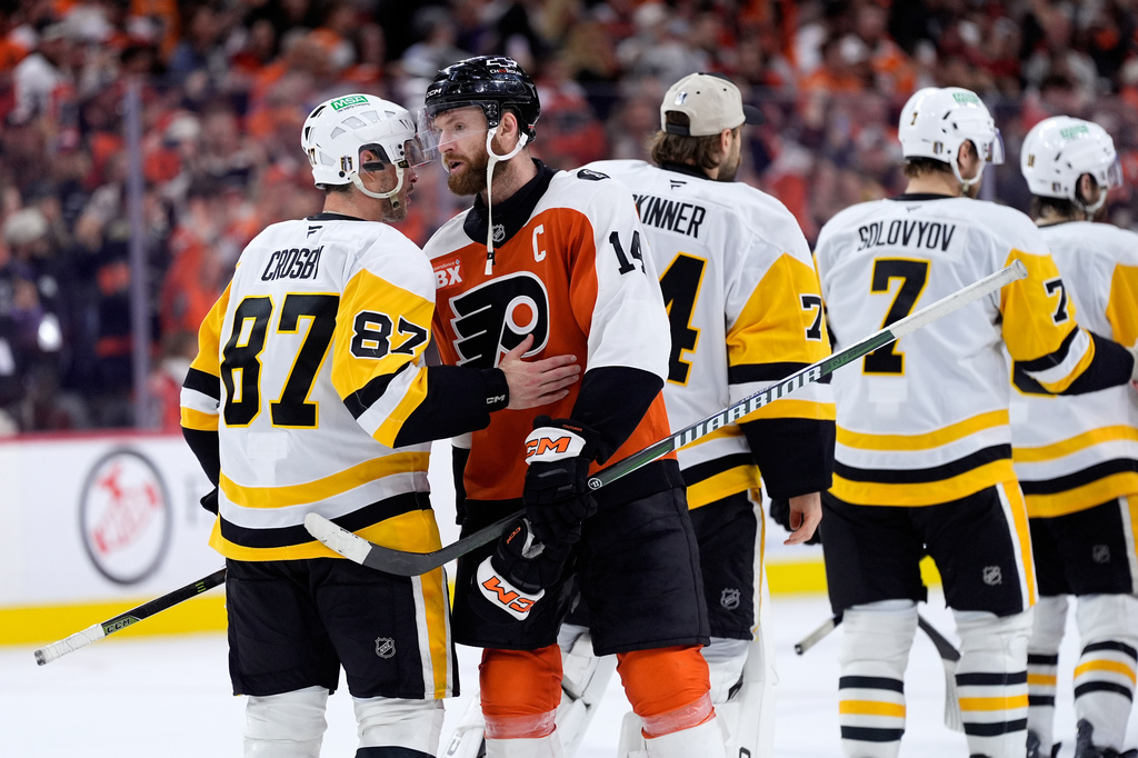 Philadelphia Flyers' Sean Couturier (14) and Pittsburgh Penguins' Sidney Crosby (87) meet after the Flyers won Game 6 in the first round of the NHL hockey Stanley Cup playoffs series Wednesday, April 29, 2026, in Philadelphia. (AP Photo/Matt Slocum)