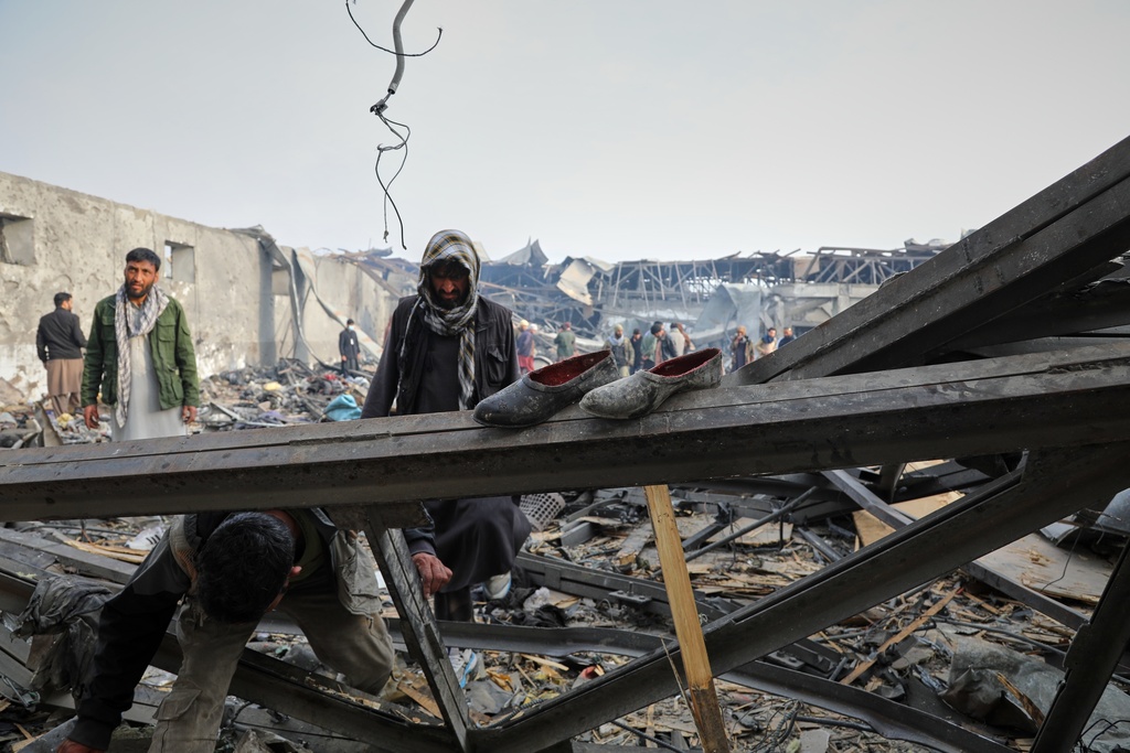 Residents and volunteers inspect the site of a late-Monday airstrike at a drug rehabilitation hospital in Kabul, Afghanistan, Tuesday, March 17, 2026. (AP Photo/Siddiqullah Alizai)