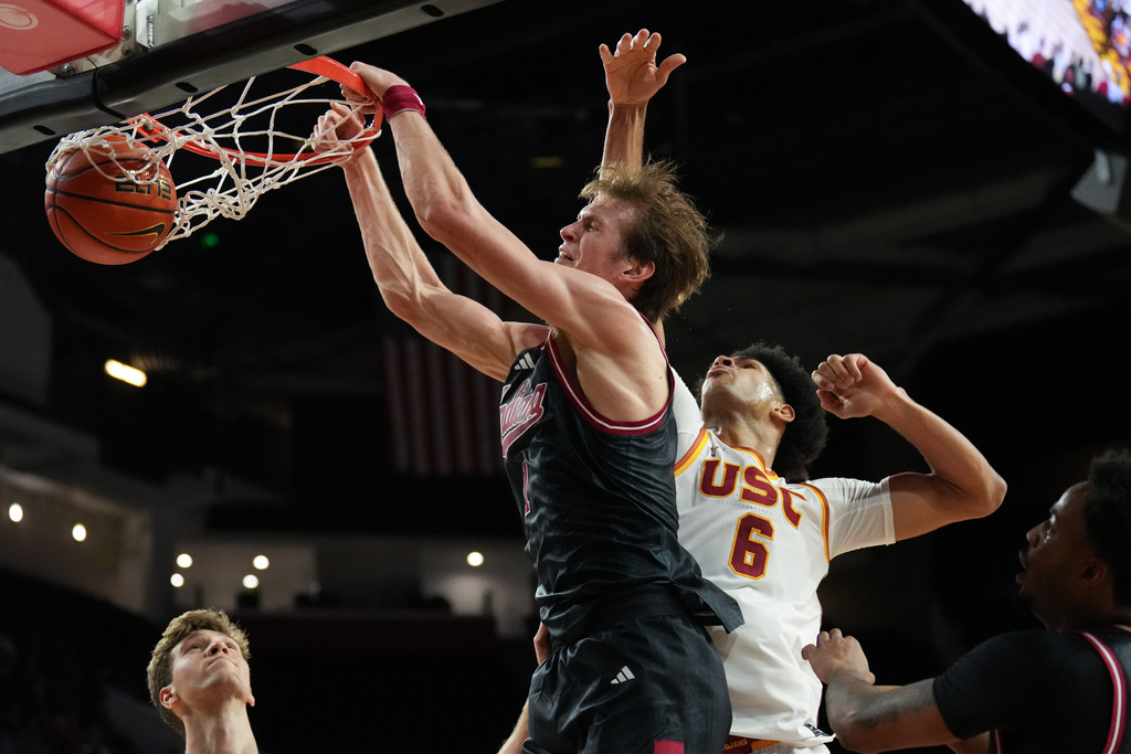 Indiana forward Reed Bailey (1) dunks under pressure by Southern California forward Jacob Cofie (6) during the first half of an NCAA college basketball game in Los Angeles, Tuesday, Feb. 3, 2026. (AP Photo/Jae C. Hong)