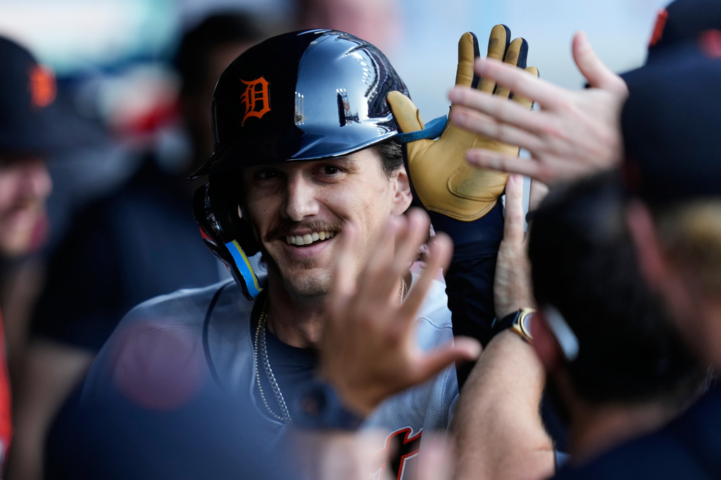 Detroit Tigers' James Outman is congratulated in the dugout after hitting a home run in the third inning of a baseball game against the Cleveland Guardians in Cleveland, Friday, June 12, 2026. (AP Photo/Sue Ogrocki)
