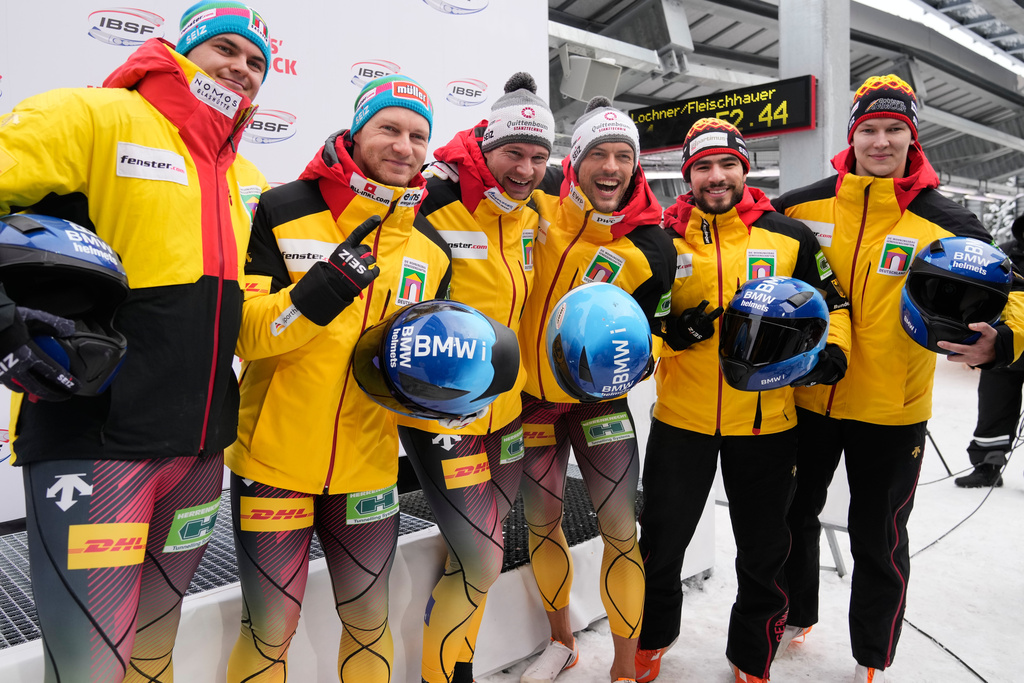 Winner Johannes Lochner and Georg Fleischhauer, second placed Francesco Friedrich and Alexander Schaller and third placed Adam Ammour and Tim Becker of Germany celebrate after the 2-man bobsleigh, at the Bobsleigh World Cup in Innsbruck, Austria, Saturday, Nov. 29, 2025. (AP Photo/Matthias Schrader)