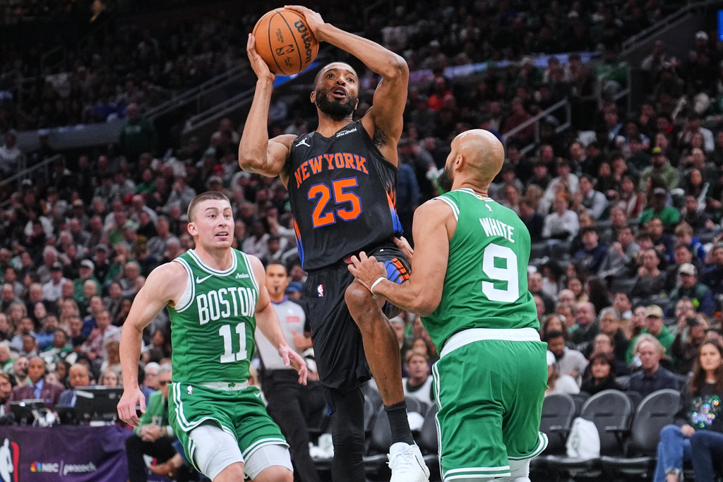 New York Knicks guard Mikal Bridges (25) drives to the basket against the Boston Celtics during the second half of an NBA basketball game, Tuesday, Dec. 2, 2025, in Boston. (AP Photo/Charles Krupa)