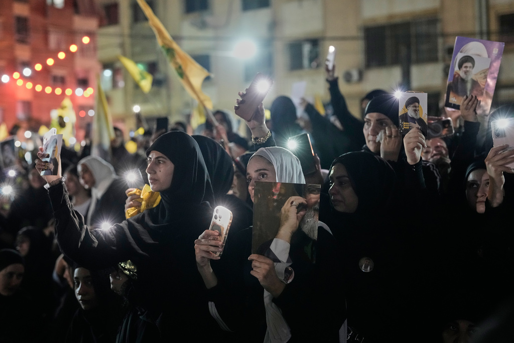 CORRECTS MONTH - People gather at the site where Hezbollah leader Hassan Nasrallah was killed in Israeli airstrikes on Sept. 27, 2024, a day before the first anniversary of his death, in the Haret Hreik suburb south of Beirut, Lebanon, Friday, Sept. 26, 2025. (AP Photo/Hassan Ammar)