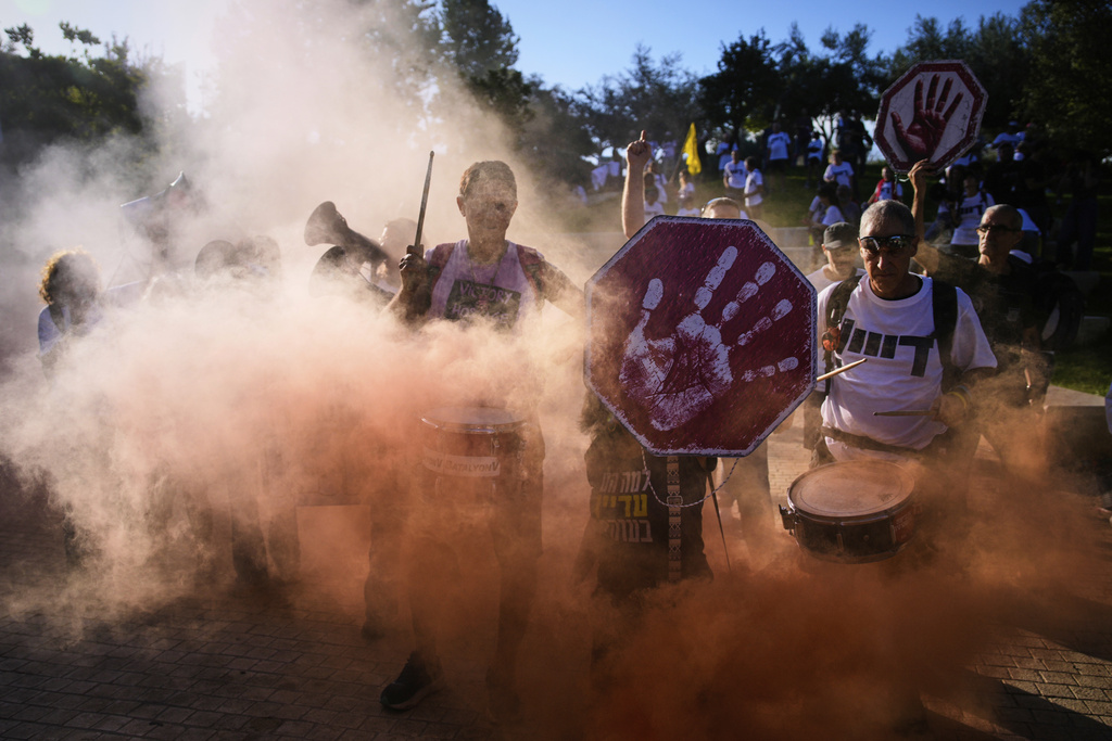 Demonstrators wave signs and shout slogans during a protest demanding the immediate release of all hostages held by Hamas and calling for the end of the war in the Gaza Strip, in Jerusalem, Wednesday, Sept. 3, 2025. (AP Photo/Ohad Zwigenberg)