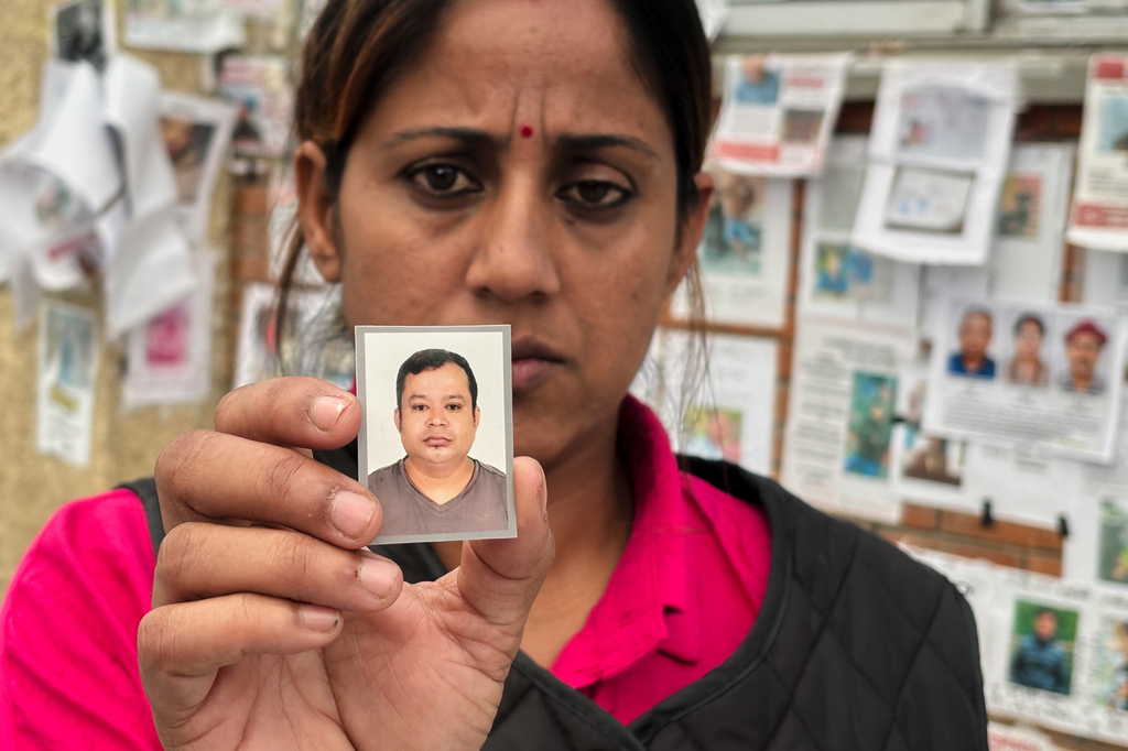 In this photo taken with a smartphone, Usha Khatri shows a photo of her husband Indra Bahadur who has been missing since last month's flood outside Tribhuvan University Teaching Hospital, in Kathmandu, Nepal, Thursday, Sept. 17, 2026. (AP photo/Upendra Man Singh)
