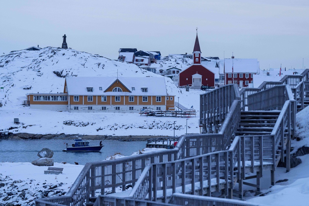 A boat travels at the sea inlet in Nuuk, Greenland, on Tuesday, Jan. 13, 2026. (AP Photo/Evgeniy Maloletka)