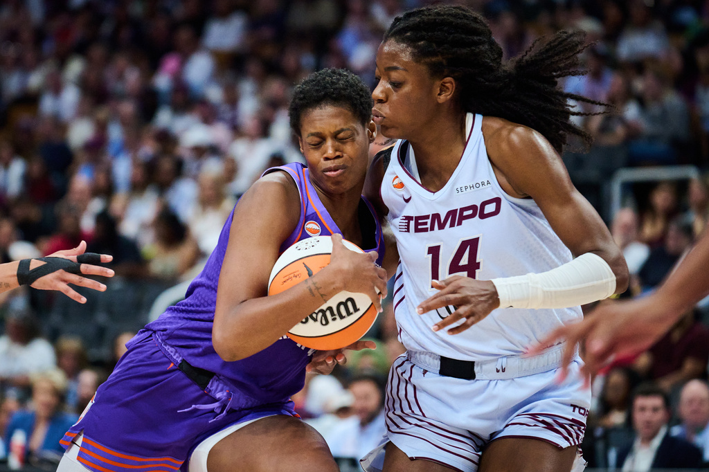 Phoenix Mercury's Valeriane Ayayi (11) crashes into Toronto Tempo's Temi Fagbenle (14) during first half of an WNBA basketball game in Toronto, on Saturday, June 27, 2026. (Sammy Kogan /The Canadian Press via AP)