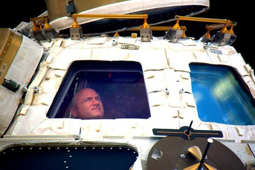 FILE - In this undated photo provided by NASA on Tuesday, March 1, 2016, astronaut Scott Kelly looks out the cupola of the International Space Station. (NASA via AP, File) FILE - In this undated photo provided by NASA on Tuesday, March 1, 2016, astronaut Scott Kelly looks out the cupola of the International Space Station. (NASA via AP, File)