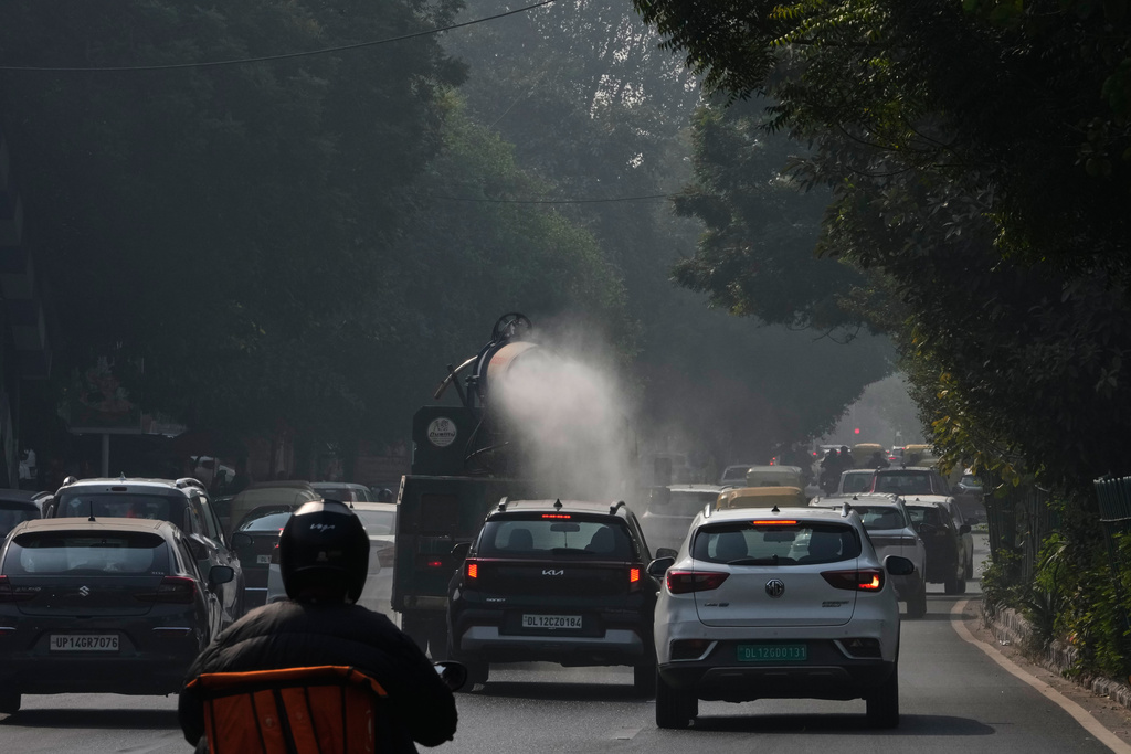 A government vehicle sprays water in an effort to control pollution in New Delhi, India, Tuesday, Nov. 18, 2025. (AP Photo/Manish Swarup)